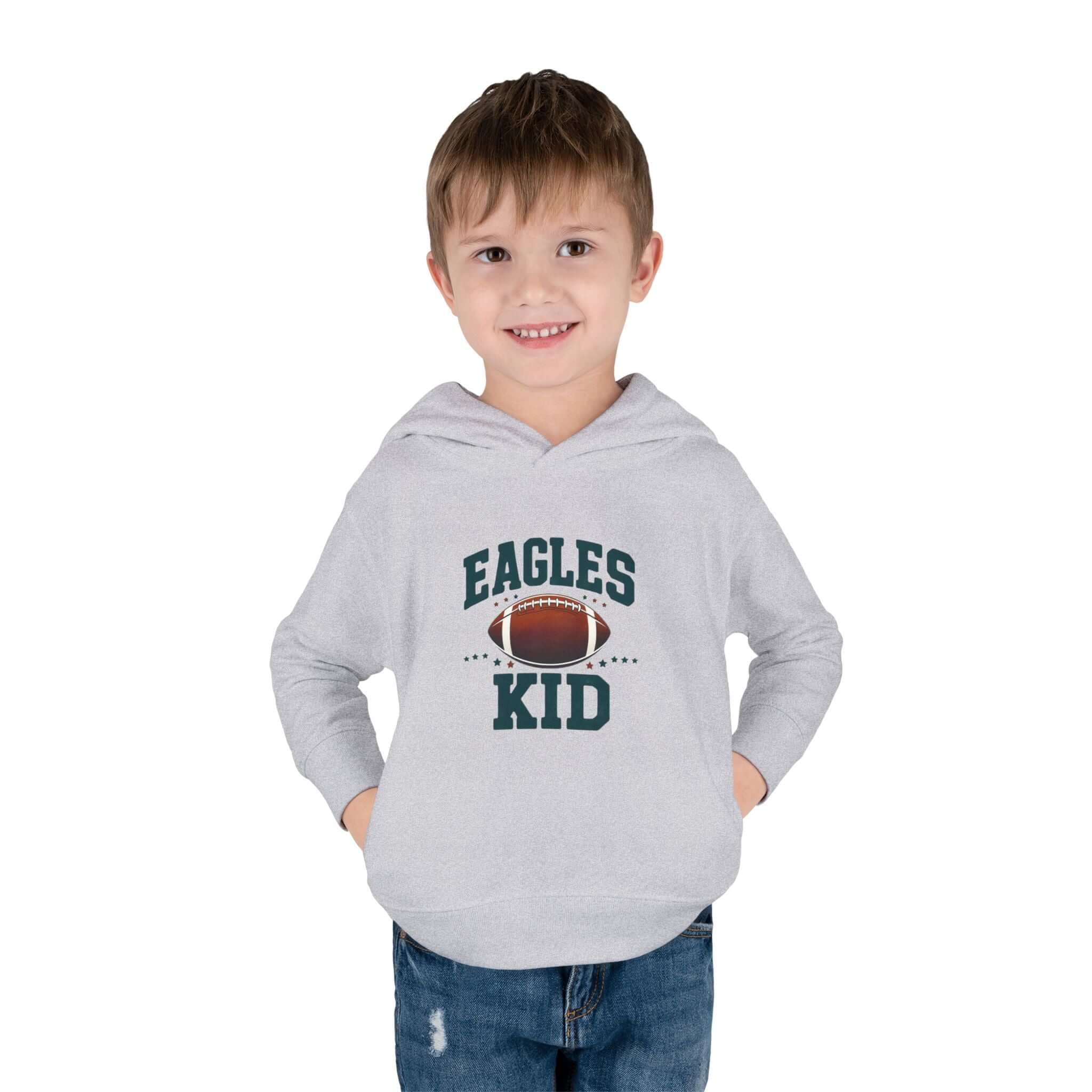 Eagles Kid football pullover hoodie worn by a smiling toddler, showcasing a football design and the team name.