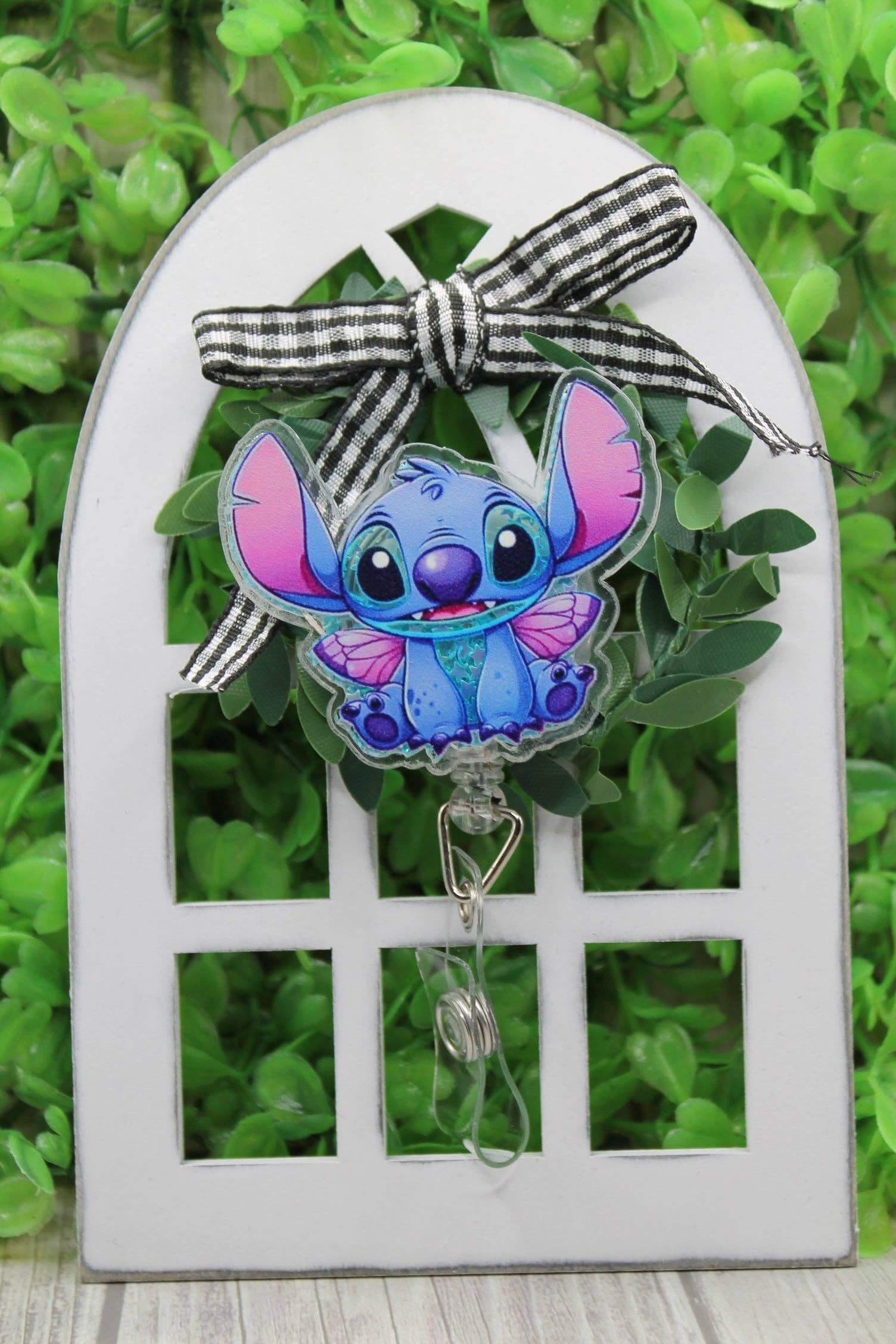 Stitch Shaker badge reel with cute character design and alligator clip, perfect for Disney fans.