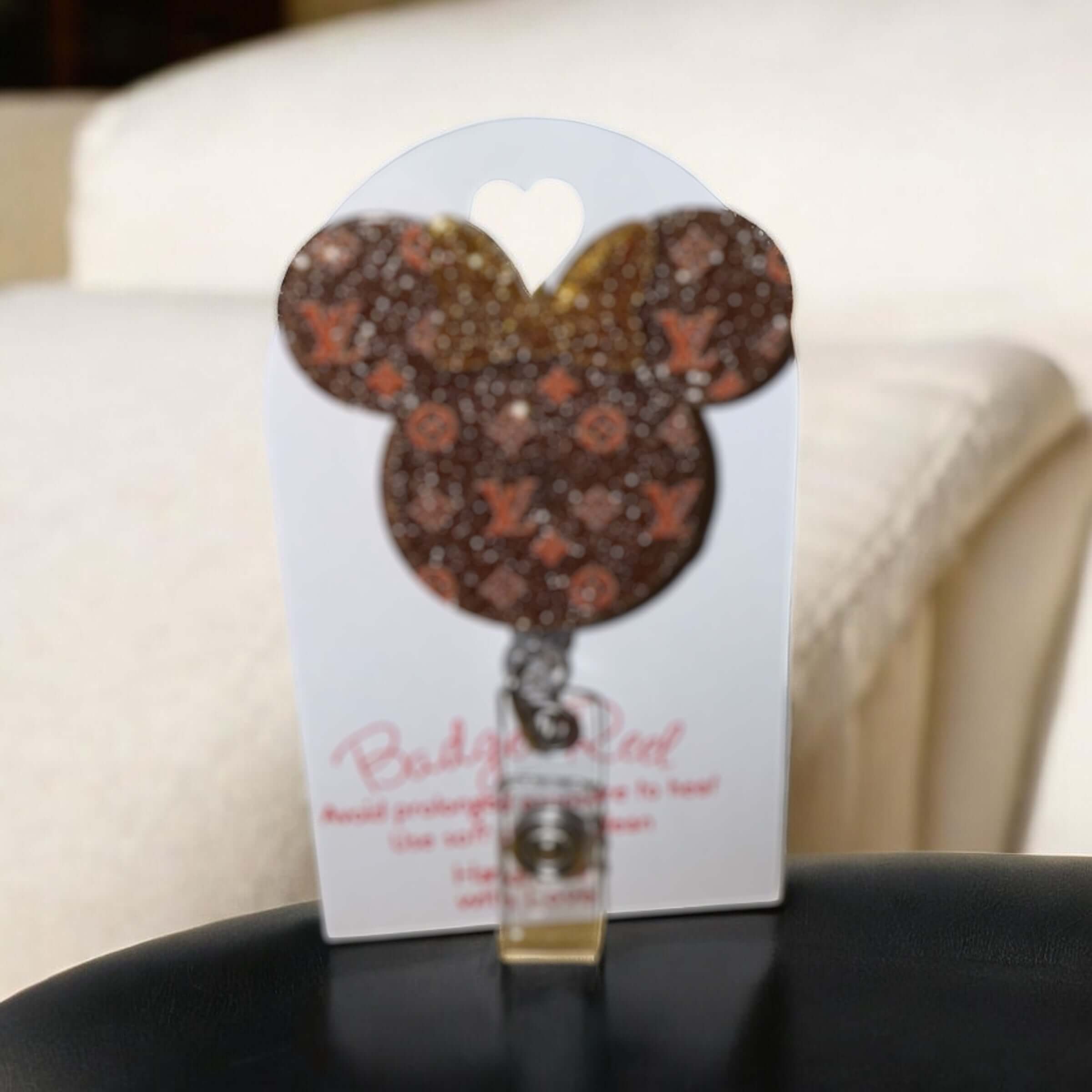 Mouse shaped badge reel with LV logo design, featuring a glittery finish and alligator clip, ideal for ID badges.