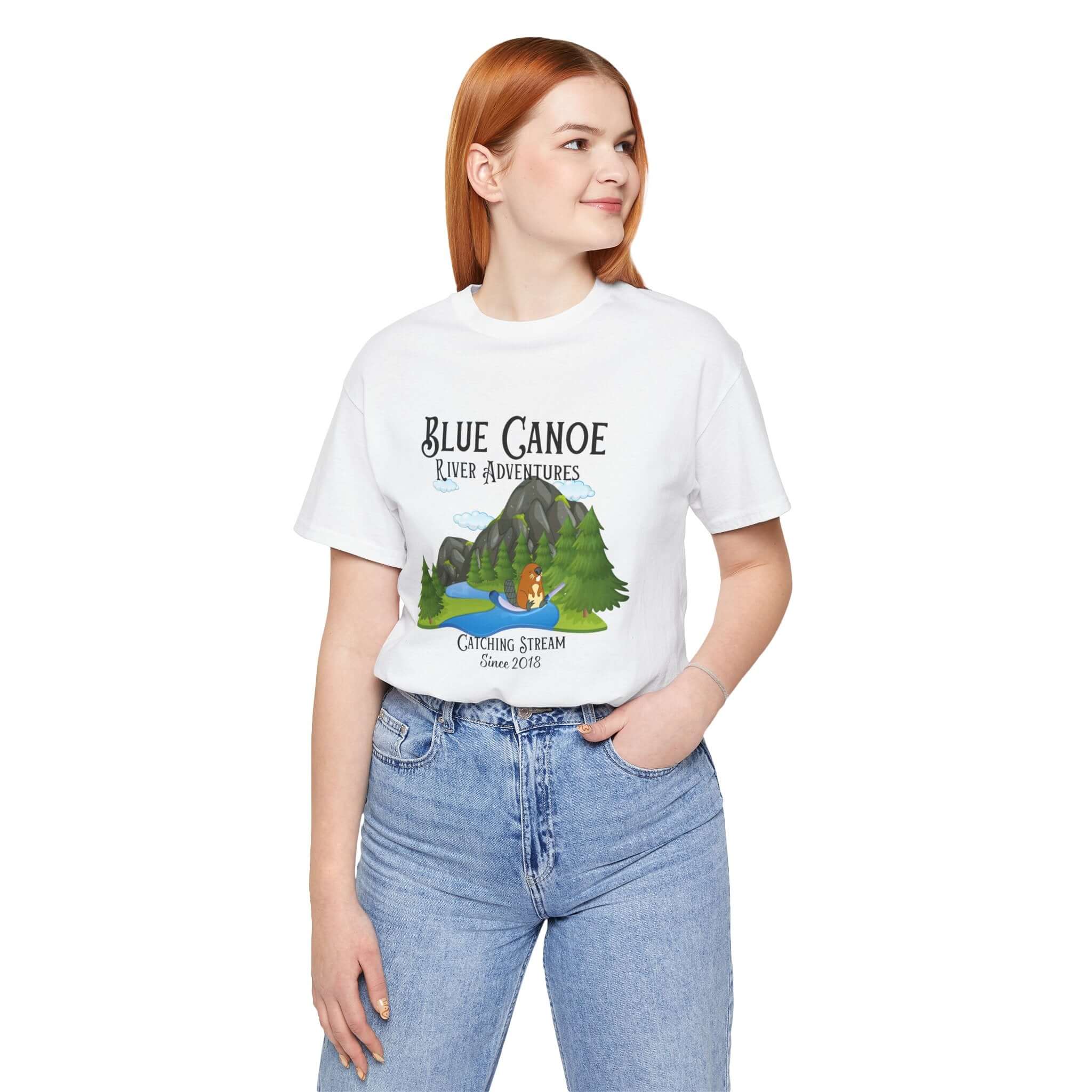 Model wearing a Blue Canoe River Adventures t-shirt featuring a scenic design with a canoe and river.