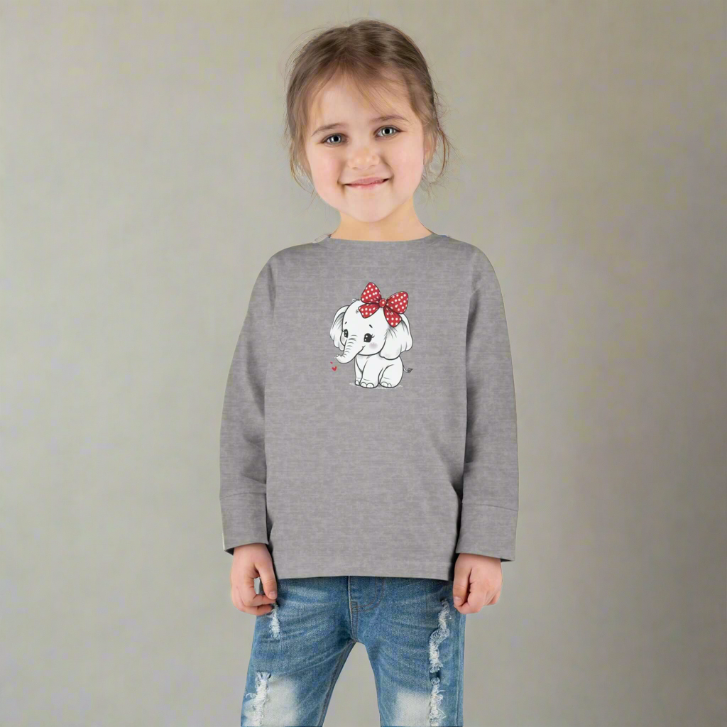 Toddler wearing a long sleeve tee with a cute baby elephant design and a red bow, perfect for elephant lovers.